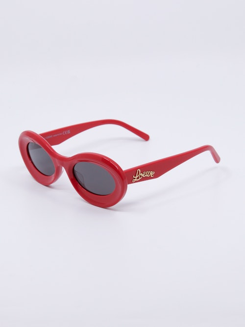Oval og rød solbrille med avrundet cateye-fasong