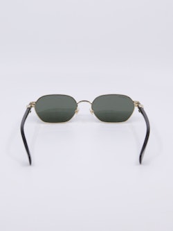 Smal metallsolbrille med gullramme og svarte brillestenger