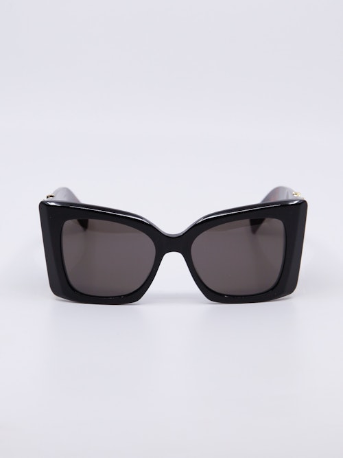 Oversized cateye solbrille med svart front og brune brillestenger
