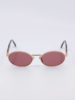 Oval metallsolbrille i gull med rosa solbrilleglass