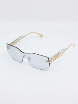 Solbrille uten ramme, gulldetaljer, bilde fra siden