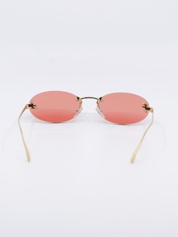 Smale, ovale solbriller i rosa og gull, bilde bakfra