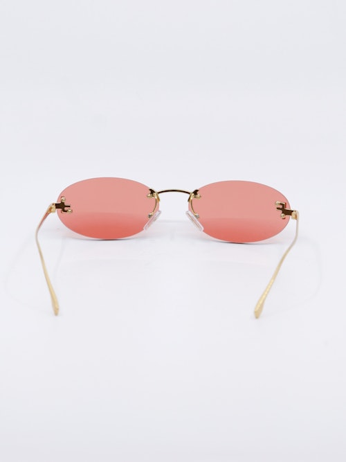 Smale, ovale solbriller i rosa og gull, bilde bakfra