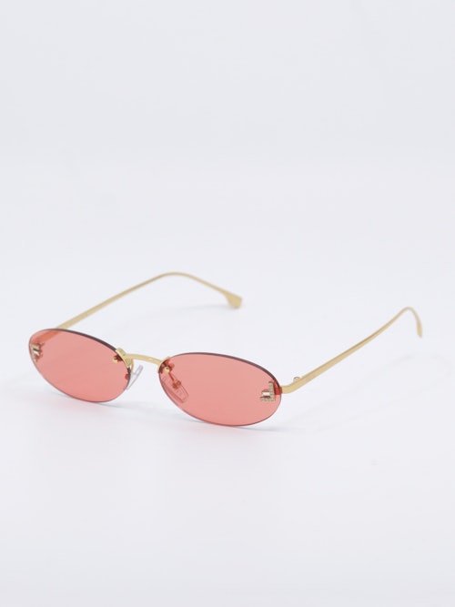 Smale, ovale solbriller i rosa og gull, bilde fra siden