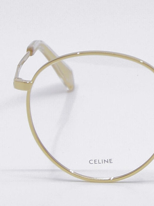 Nærbilde av rund metallbrille i gull fra Celine